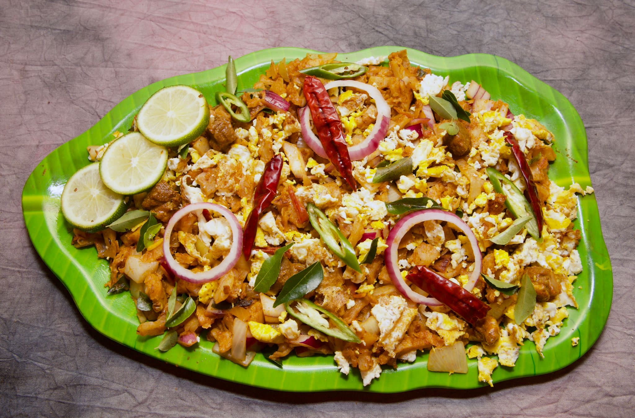 Chicken kottu, roti chopped on the griddle with chicken and spices