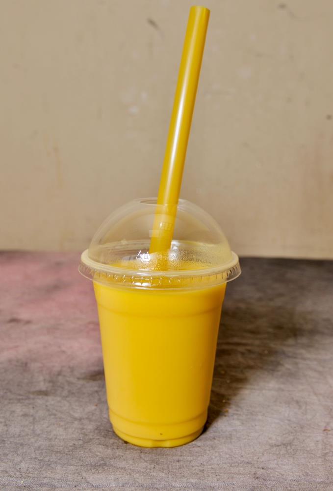 A tall glass of mango milkshake