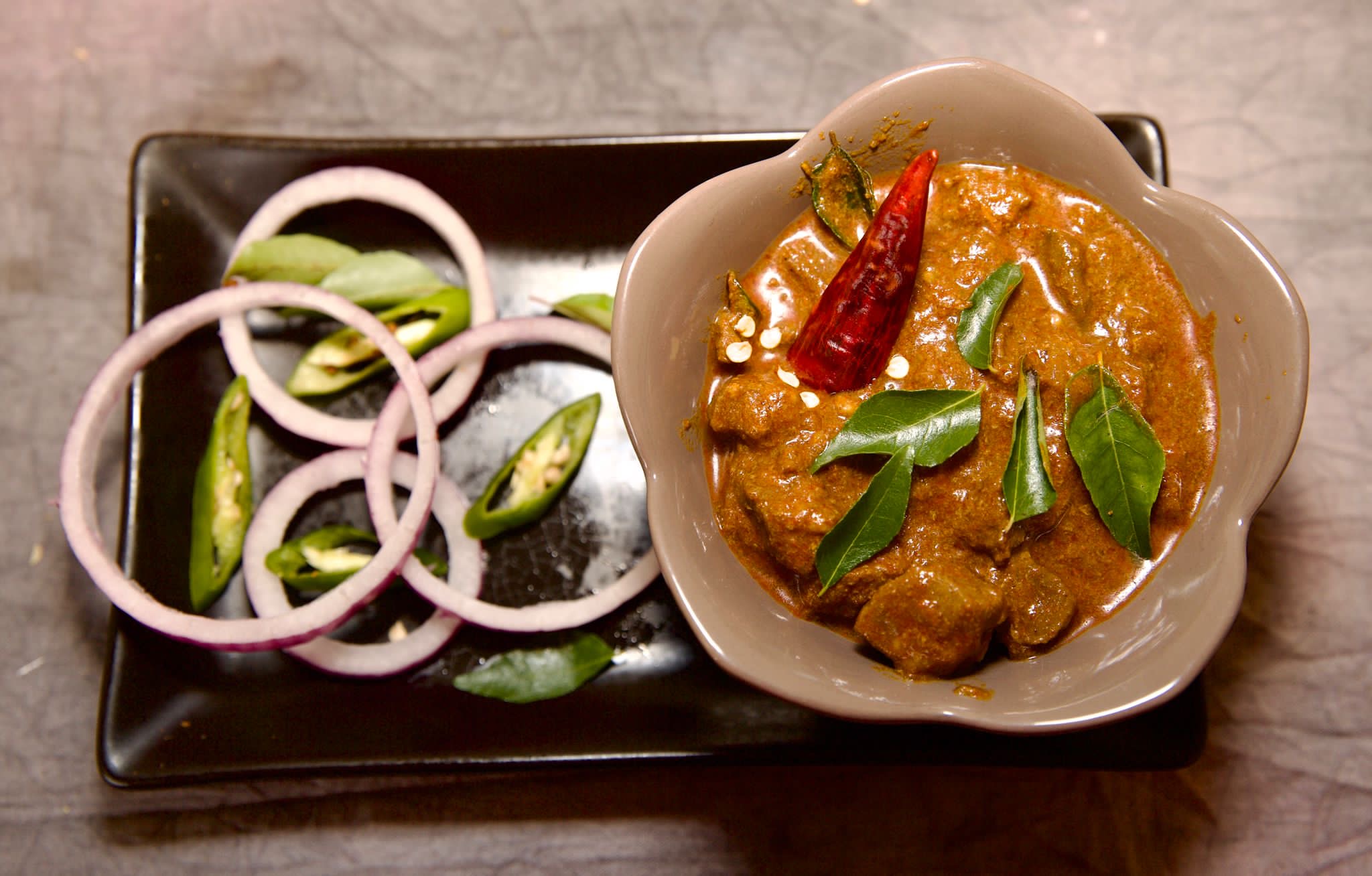 Slow-cooked mutton curry served in a bowl