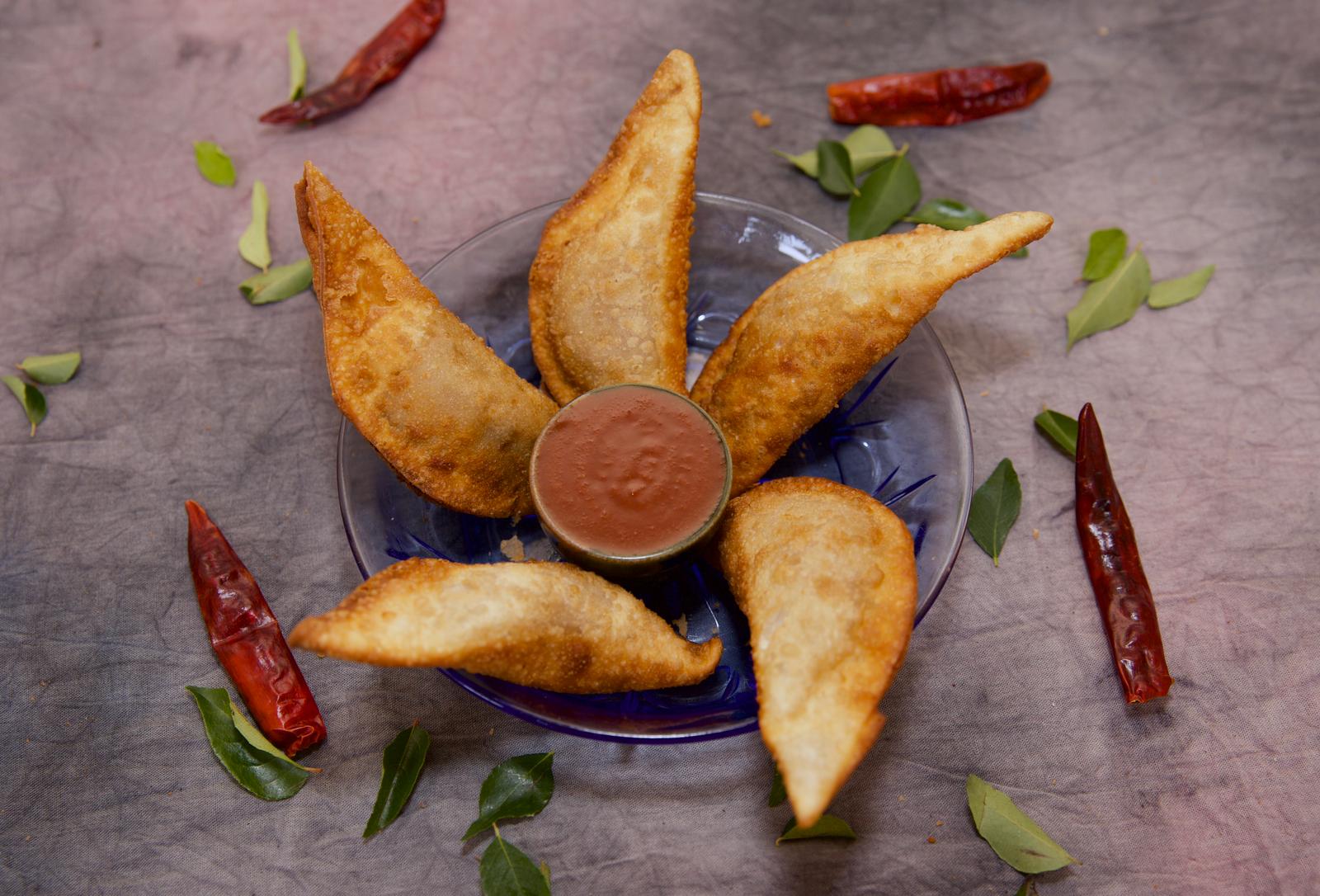 Crispy vegetable somas served with a dipping sauce